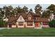 Stunning two-story home with a brick and wood exterior, and landscaped lawn at 3813 Peaceful Creek Trl, Zebulon, NC 27597