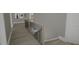 Bright hallway with modern railing, wood floors, and plenty of natural light creating a welcoming space at 3813 Peaceful Creek Trl, Zebulon, NC 27597