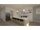 Well-lit kitchen boasts stainless steel appliances, a spacious island with bar seating, and stylish pendant lights at 3813 Peaceful Creek Trl, Zebulon, NC 27597