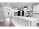 White kitchen with breakfast bar, stainless steel appliances, and built-in bench seating at 3813 Peaceful Creek Trl, Zebulon, NC 27597
