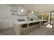 Open concept kitchen features a large island, modern lighting, and seamless connection to the dining area at 3813 Peaceful Creek Trl, Zebulon, NC 27597