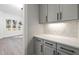 Gray kitchen cabinets and white quartz countertops in this butler's pantry at 3813 Peaceful Creek Trl, Zebulon, NC 27597