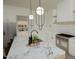 Modern kitchen with white cabinets, marble countertops, and stainless steel appliances provides luxurious cooking space at 3813 Peaceful Creek Trl, Zebulon, NC 27597