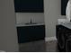 Well-equipped laundry room with sleek cabinetry, modern sink, and stylish washer and dryer units at 3813 Peaceful Creek Trl, Zebulon, NC 27597