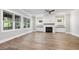 Living room with hardwood floors, fireplace, and built-in shelving at 3813 Peaceful Creek Trl, Zebulon, NC 27597