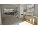 Bright living room featuring hardwood floors, a staircase, and large windows with a view to the outdoors at 3813 Peaceful Creek Trl, Zebulon, NC 27597