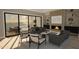 Inviting living room with a fireplace, comfortable seating, and seamless access to the outdoor balcony at 3813 Peaceful Creek Trl, Zebulon, NC 27597
