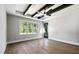 Main bedroom with hardwood floors, tray ceiling, and access to backyard at 3813 Peaceful Creek Trl, Zebulon, NC 27597
