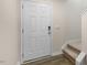 Front entry with white door, keypad lock, and carpeted stairs at 412 Honeycutt Oaks Dr, Angier, NC 27501