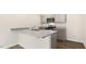 Modern kitchen with gray cabinets, granite countertops, and stainless steel appliances at 412 Honeycutt Oaks Dr, Angier, NC 27501