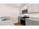 Modern kitchen with gray cabinets, granite countertops, and stainless steel appliances at 412 Honeycutt Oaks Dr, Angier, NC 27501