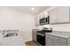 Modern kitchen with gray cabinets, granite countertops, and stainless steel appliances at 422 Honeycutt Oaks Dr, Angier, NC 27501