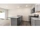 Modern kitchen with gray cabinets, granite countertops, and stainless steel appliances at 422 Honeycutt Oaks Dr, Angier, NC 27501