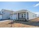 New home with gray siding, two-car garage, and a covered porch at 483 White Birch Ln, Angier, NC 27501
