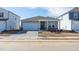 Newly constructed home with gray siding, brick accents, and a covered porch at 483 White Birch Ln, Angier, NC 27501