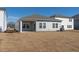 Gray house exterior with a covered patio and grassy yard at 483 White Birch Ln, Angier, NC 27501