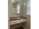 Bathroom with a white vanity, dark countertop, drawers, and large mirror at 494 S Mason St, Coats, NC 27521