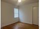 Bedroom featuring a large window and wood floors at 494 S Mason St, Coats, NC 27521