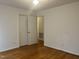 Bedroom featuring wood floors, closet and hallway access at 494 S Mason St, Coats, NC 27521