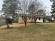 Cozy brick home featuring a covered carport, and a well-maintained lawn at 494 S Mason St, Coats, NC 27521