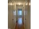 Hallway with hardwood floors and several doors at 494 S Mason St, Coats, NC 27521