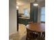 Cozy kitchen featuring dark green cabinets, tan countertops, a stainless steel range and a wood table with chairs at 494 S Mason St, Coats, NC 27521