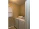 Laundry room featuring a washer and dryer with natural lighting through a window at 494 S Mason St, Coats, NC 27521