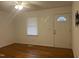 Bright living room featuring hardwood floors, a ceiling fan, and a front door with decorative window at 494 S Mason St, Coats, NC 27521