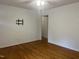 Simple living room with hardwood floors, a TV mount, and white walls with natural lighting at 494 S Mason St, Coats, NC 27521