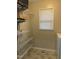 Storage room with adjustable metal shelving units, a laundry machine, and natural light from a window at 494 S Mason St, Coats, NC 27521