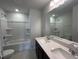 Modern bathroom with double sinks, quartz countertops, and a shower and bath combination at 50 Cordoba Dr, Franklinton, NC 27525