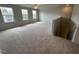 Expansive bonus room with carpeting, large windows, and staircase leading to additional space at 50 Cordoba Dr, Franklinton, NC 27525