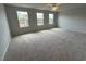 Spacious bonus room with three windows and neutral carpeting for comfortable living space at 50 Cordoba Dr, Franklinton, NC 27525
