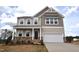 Charming two-story home featuring a two-car garage, stone accents, and a welcoming front porch at 50 Cordoba Dr, Franklinton, NC 27525