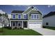 Charming two-story home featuring a two-car garage, stone accents, and a welcoming front porch at 50 Cordoba Dr, Franklinton, NC 27525