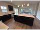 Modern kitchen features stainless steel appliances, an island with white countertop, and black cabinets at 50 Cordoba Dr, Franklinton, NC 27525
