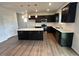 Modern kitchen features stainless steel appliances, an island with white countertop, and black cabinets at 50 Cordoba Dr, Franklinton, NC 27525