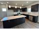 Modern kitchen features stainless steel appliances, an island with white countertop, and black cabinets at 50 Cordoba Dr, Franklinton, NC 27525