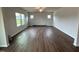 Large living room has wood-look floors and lots of natural light from the multiple windows at 50 Cordoba Dr, Franklinton, NC 27525