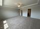 Spacious main bedroom featuring neutral colors, carpet, ceiling fan, and ensuite bathroom at 50 Cordoba Dr, Franklinton, NC 27525