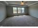Large main bedroom with carpet, multiple windows, and tray ceiling at 50 Cordoba Dr, Franklinton, NC 27525