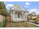 Cozy gray home featuring a quaint covered porch with decorative trim and a well-maintained yard at 520 S Bloodworth St, Raleigh, NC 27601