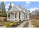 Charming two-story home with a decorative porch, manicured landscaping, and a view of the city skyline in the background at 520 S Bloodworth St, Raleigh, NC 27601