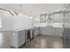 Modern kitchen boasts gray cabinets, stainless appliances, a wine cooler, and pendant lighting over the island at 520 S Bloodworth St, Raleigh, NC 27601