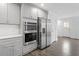Gray kitchen cabinets, stainless steel appliances and hardwood floors at 520 S Bloodworth St, Raleigh, NC 27601