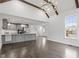 Open concept space featuring a kitchen and vaulted ceilings with hardwood floors, a chandelier, and large windows at 520 S Bloodworth St, Raleigh, NC 27601