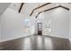 Bright living room with vaulted ceiling, exposed wood beams, chandelier, large windows, and hardwood floors at 520 S Bloodworth St, Raleigh, NC 27601