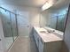 Bathroom with double sink vanity, large mirror, and glass-enclosed shower at 60 Cordoba Dr, Franklinton, NC 27525