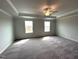 Spacious bedroom featuring plush carpeting, two windows, and a ceiling fan at 60 Cordoba Dr, Franklinton, NC 27525