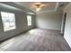 Large bedroom featuring carpeting, two windows, and tray ceiling at 60 Cordoba Dr, Franklinton, NC 27525